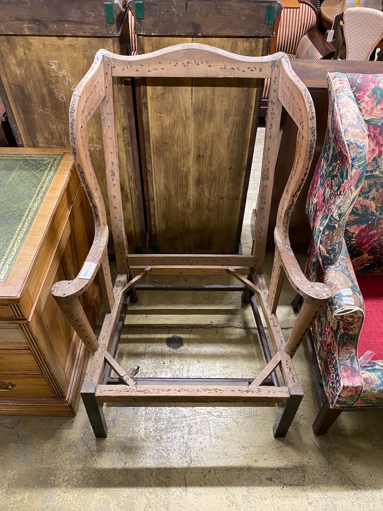 A 19th century wing back armchair frame, width 83cm, depth 60cm, height 114cm